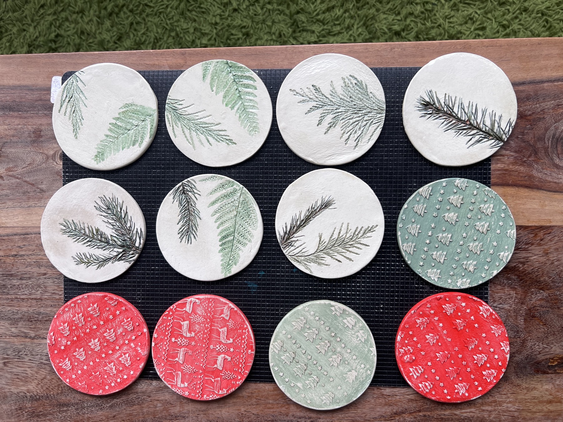A collection of botanical round decorations in sage, cream and coral